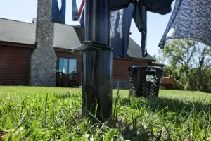 Clothesline ground insert and adjustment